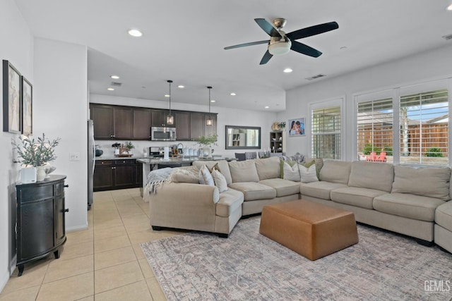 living area featuring light tile patterned floors, visible vents, ceiling fan, and recessed lighting