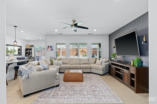 living area featuring light tile patterned floors, visible vents, recessed lighting, and a ceiling fan