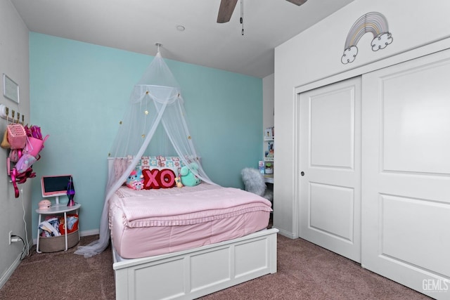 carpeted bedroom featuring a closet, baseboards, and ceiling fan