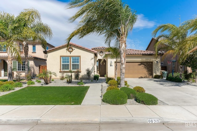 mediterranean / spanish home featuring a tiled roof, concrete driveway, a front yard, stucco siding, and an attached garage