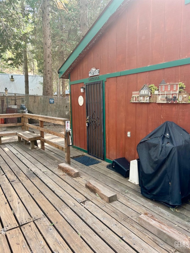 wooden deck featuring area for grilling