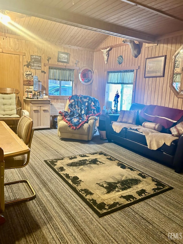 carpeted living room featuring beam ceiling, wooden walls, and wood ceiling