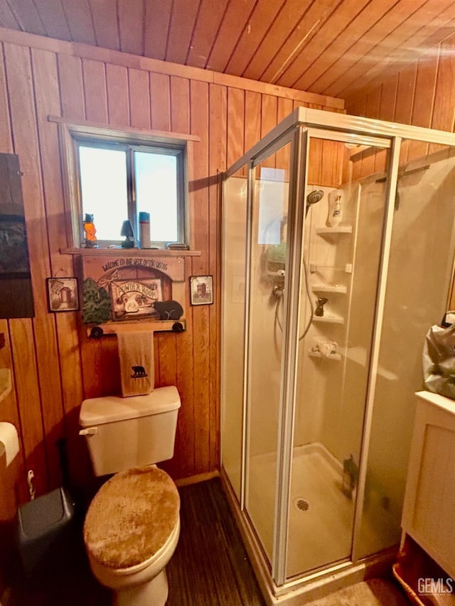 bathroom with toilet, a shower with door, wooden walls, and wooden ceiling