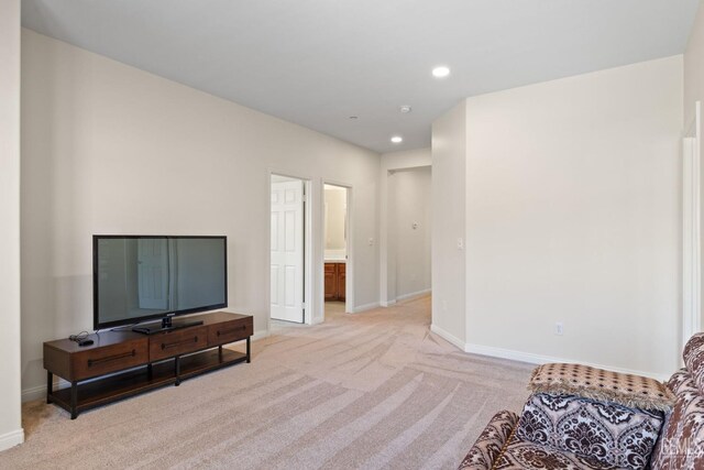 sitting room with light carpet, baseboards, and recessed lighting
