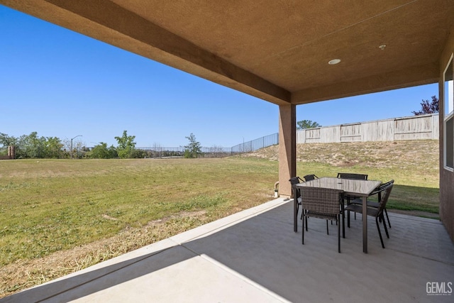 view of patio / terrace with outdoor dining area and fence