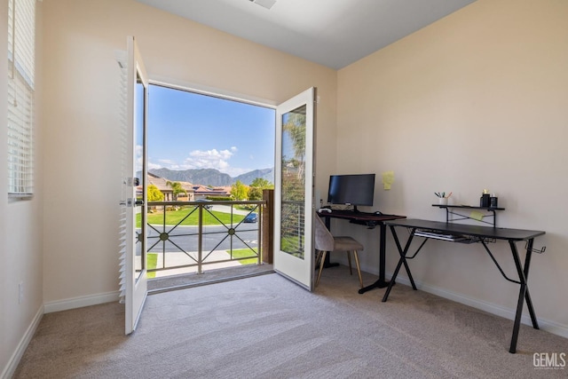 carpeted home office featuring baseboards