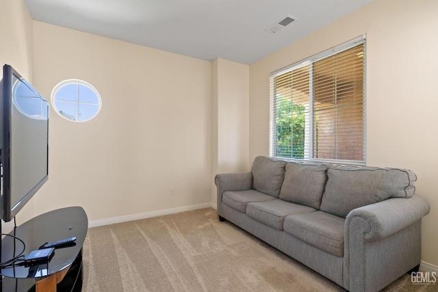 living room with light carpet, baseboards, and visible vents