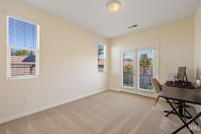 office area with carpet floors, visible vents, and baseboards