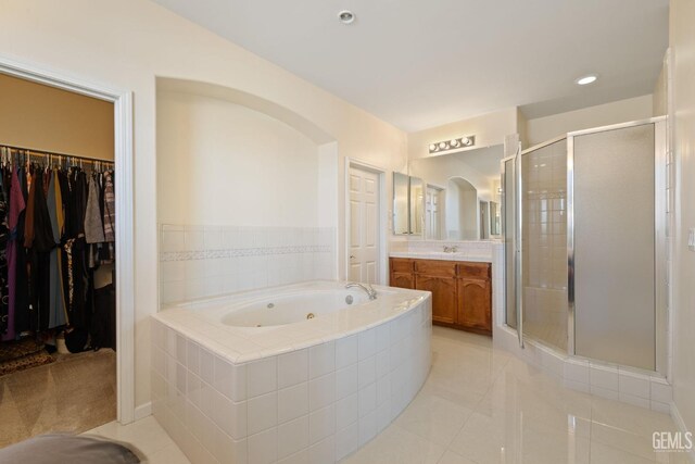 full bath with a shower stall, a tub with jets, vanity, tile patterned flooring, and recessed lighting