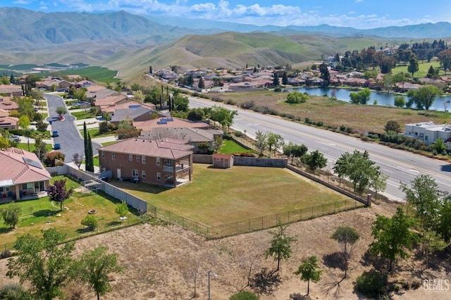 bird's eye view with a water and mountain view and a residential view