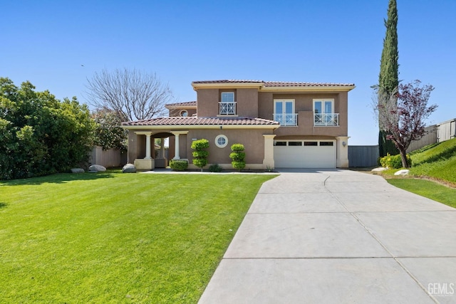 mediterranean / spanish-style home with a balcony, concrete driveway, an attached garage, a front yard, and stucco siding