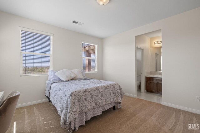 bedroom featuring baseboards, visible vents, light colored carpet, and multiple windows