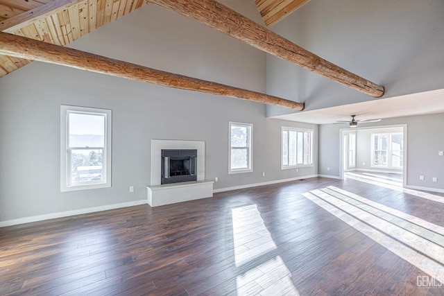 unfurnished living room with beamed ceiling, ceiling fan, dark hardwood / wood-style floors, and high vaulted ceiling