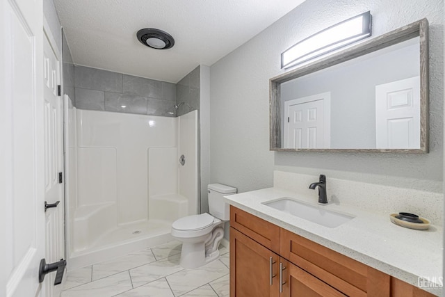 bathroom with toilet, a shower, a textured ceiling, and vanity