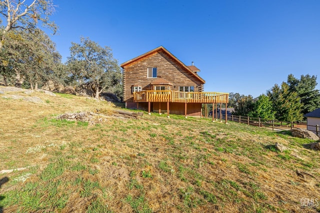 rear view of property featuring a deck