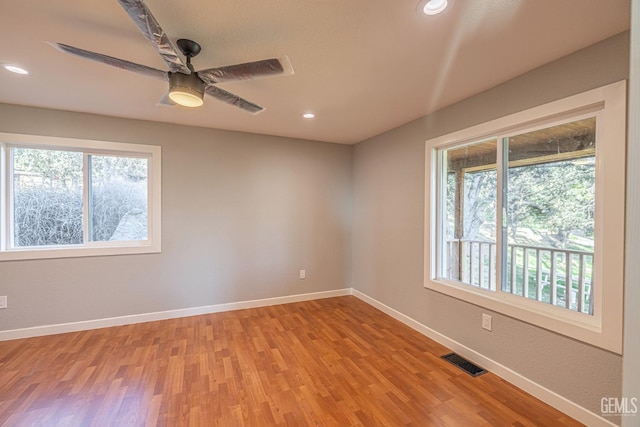 empty room featuring ceiling fan and light hardwood / wood-style flooring