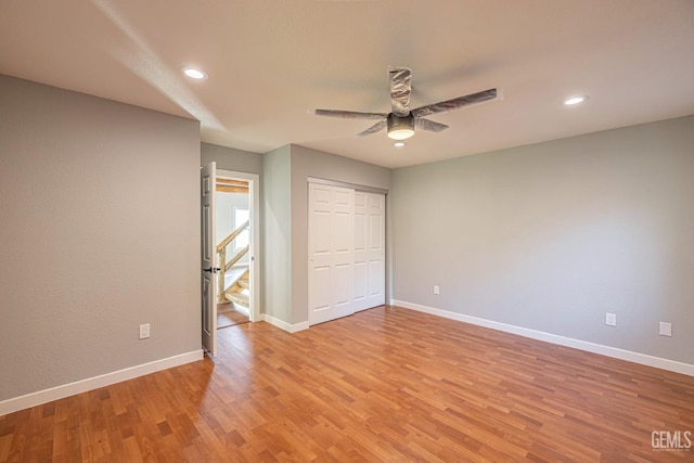 unfurnished bedroom with light wood-type flooring, a closet, and ceiling fan