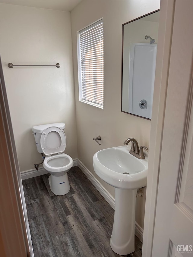 bathroom featuring wood finished floors, toilet, and baseboards