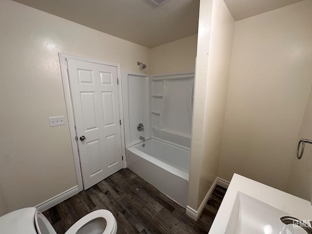 full bathroom featuring toilet, shower / tub combination, baseboards, and wood finished floors