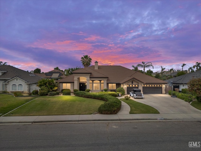 13206 Monarch Palm Ave, Bakersfield, CA 93314 - view of front of property featuring a tile roof, driveway, an attached garage, and a front lawn