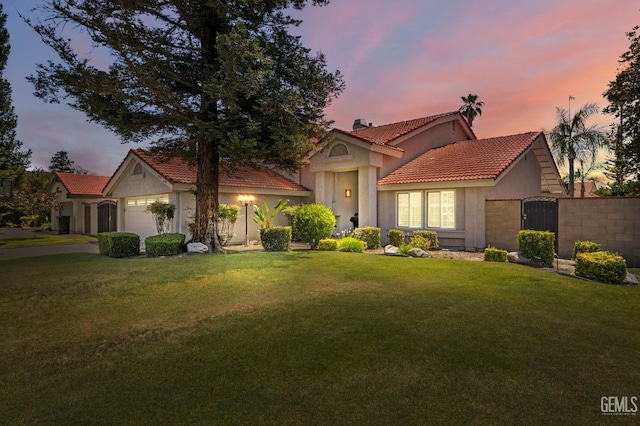 9717 Willow Oak Ct, Bakersfield, CA 93311 - mediterranean / spanish-style house with stucco siding, a tiled roof, an attached garage, and a front yard