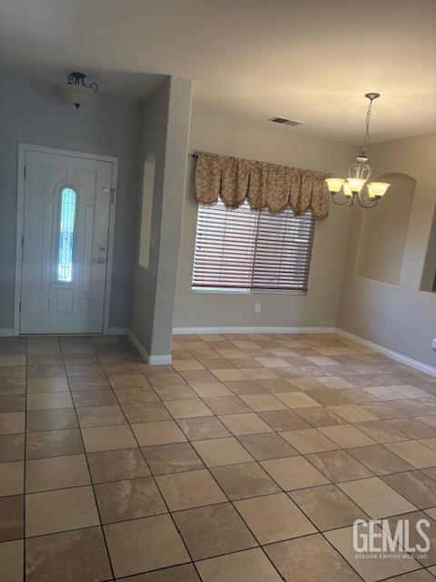 12006 Roaring River Ave, Bakersfield, CA 93311 - entryway featuring healthy amount of natural light, light tile patterned floors, and a chandelier