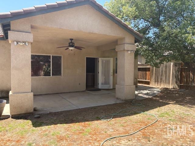 12006 Roaring River Ave, Bakersfield, CA 93311 - back of house with a ceiling fan, stucco siding, and a patio area