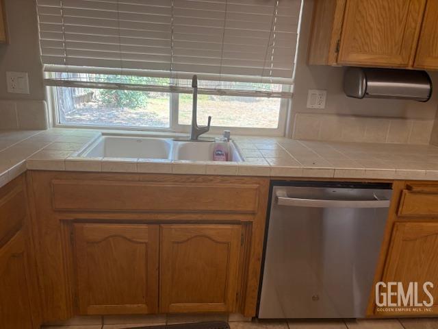 12006 Roaring River Ave, Bakersfield, CA 93311 - kitchen with dishwasher and tile counters