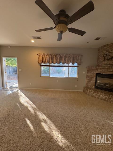 12006 Roaring River Ave, Bakersfield, CA 93311 - unfurnished living room with plenty of natural light, carpet floors, a fireplace, and ceiling fan