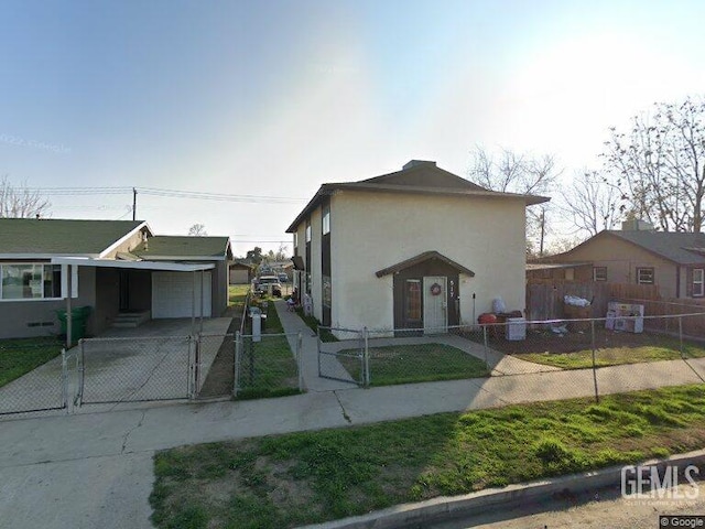 517 Lincoln Ave, Bakersfield, CA 93308 - view of front facade featuring a gate, concrete driveway, a fenced front yard, stucco siding, and an attached carport