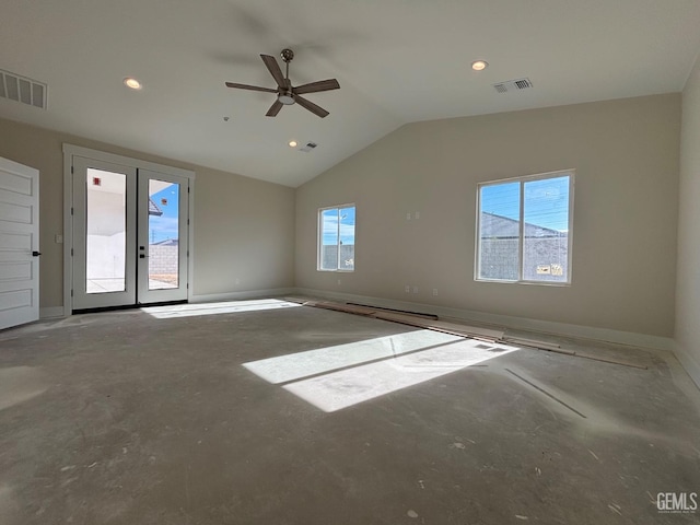 spare room with lofted ceiling, a healthy amount of sunlight, and visible vents