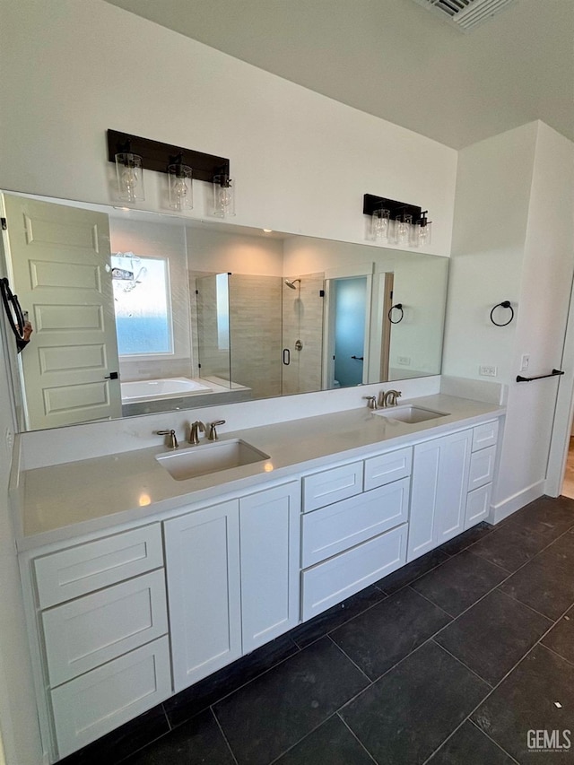 full bath featuring double vanity, a shower stall, visible vents, and a sink