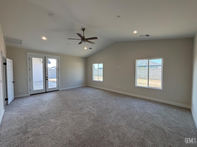 spare room featuring a ceiling fan, vaulted ceiling, visible vents, and carpet