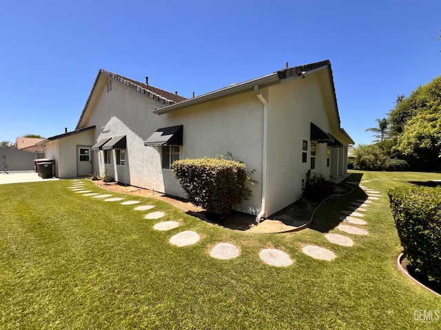 4812 Prairie Meadows Way, Bakersfield, CA 93312 - rear view of property with stucco siding and a yard