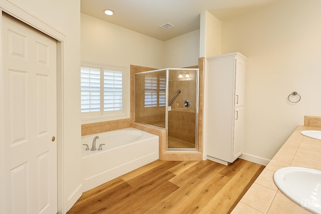 4812 Prairie Meadows Way, Bakersfield, CA 93312 - bathroom featuring a bath, a shower stall, wood finished floors, and double vanity
