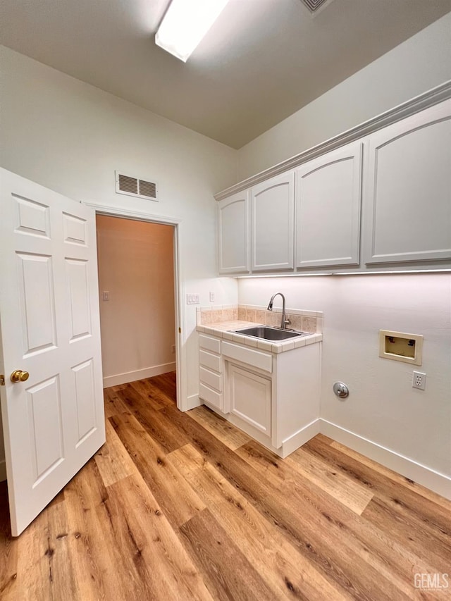 4812 Prairie Meadows Way, Bakersfield, CA 93312 - laundry area featuring hookup for a washing machine, light wood-type flooring, and cabinet space