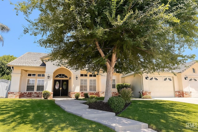 4812 Prairie Meadows Way, Bakersfield, CA 93312 - view of front facade with stucco siding, a front yard, a garage, driveway, and stone siding