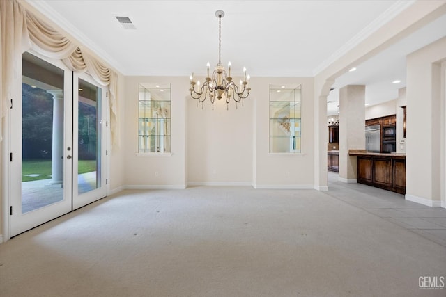 unfurnished dining area featuring a notable chandelier, crown molding, and light carpet