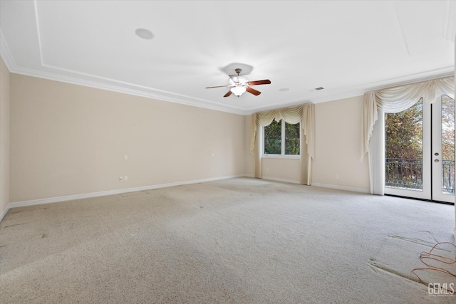 spare room with ceiling fan, ornamental molding, and light carpet