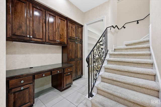 interior space featuring tile patterned flooring and built in desk