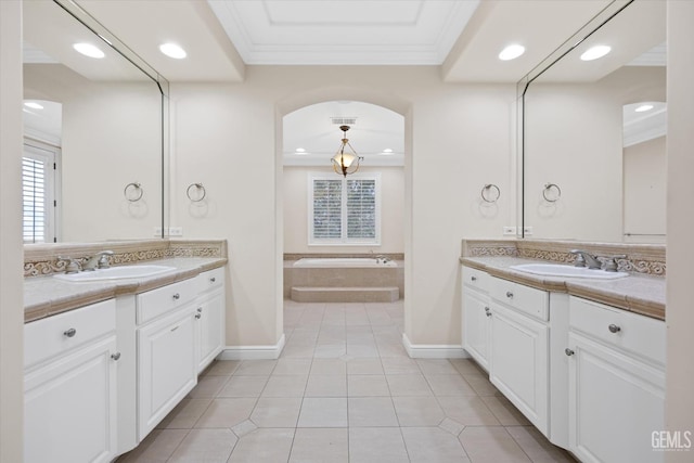 bathroom featuring tile patterned floors, vanity, ornamental molding, and tiled bath