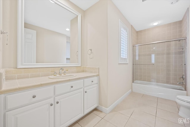 full bathroom featuring vanity, tiled shower / bath, tile patterned flooring, toilet, and tasteful backsplash