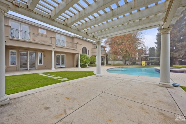 view of swimming pool featuring a pergola, a patio, and a yard