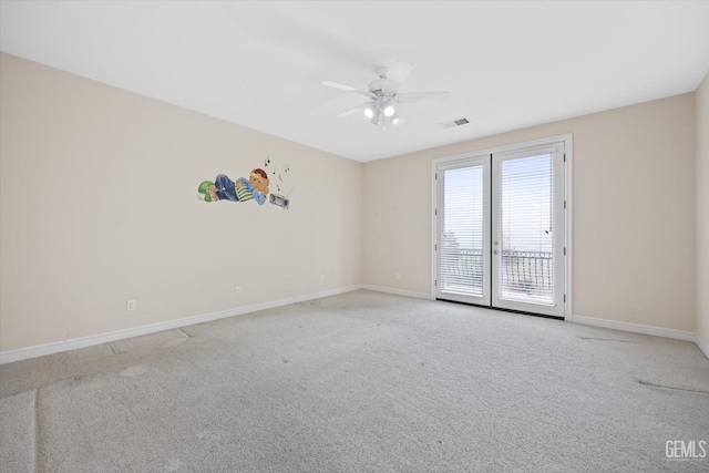 empty room featuring ceiling fan, light colored carpet, and french doors