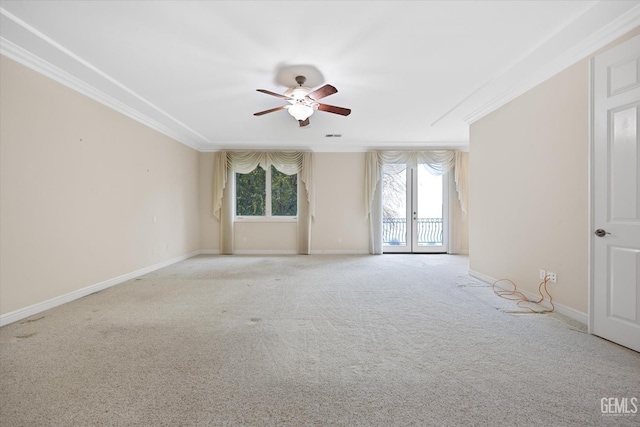 carpeted spare room featuring ceiling fan, french doors, and ornamental molding