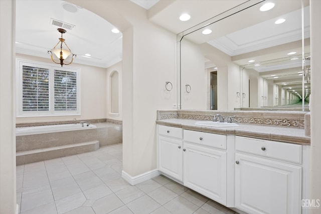 bathroom featuring tile patterned floors, vanity, crown molding, and tiled tub