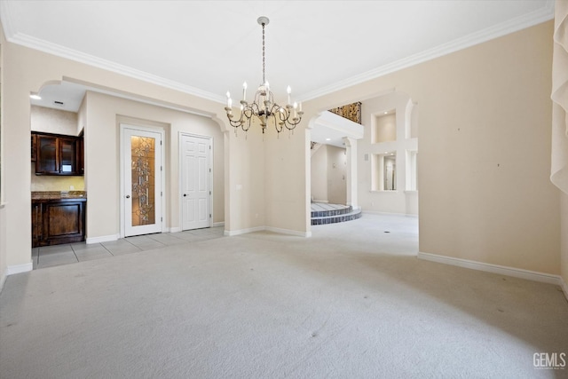 carpeted empty room with crown molding and an inviting chandelier