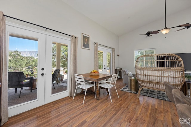 dining space with french doors, vaulted ceiling, ceiling fan, and hardwood / wood-style floors