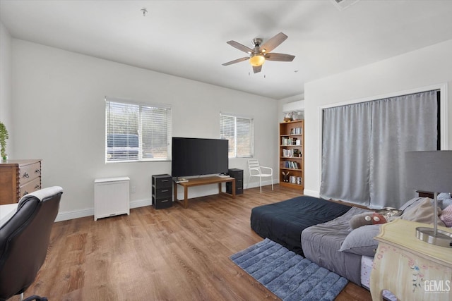 living room with light hardwood / wood-style floors and ceiling fan