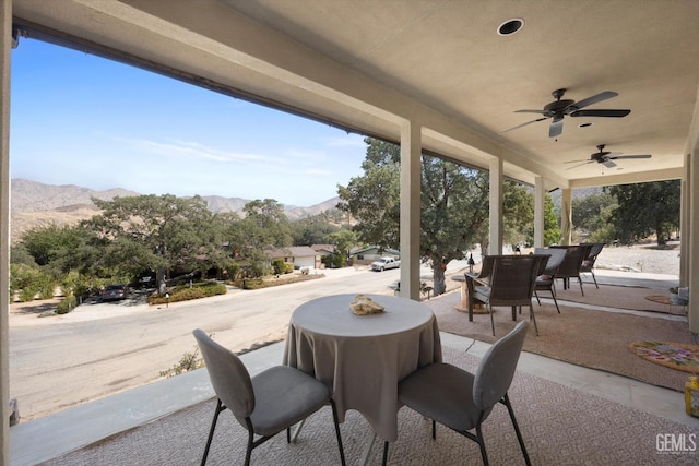 view of patio featuring a mountain view and ceiling fan